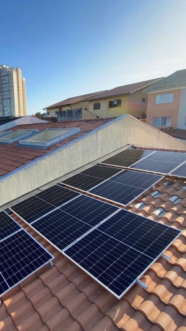 Técnico a instalar painéis solares num telhado